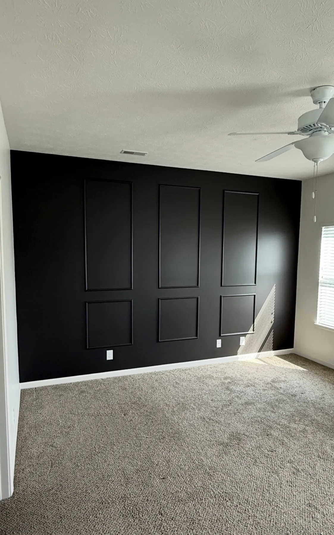 Jones & Sons accent-wall project with a rich navy finish and crisp panel detail.