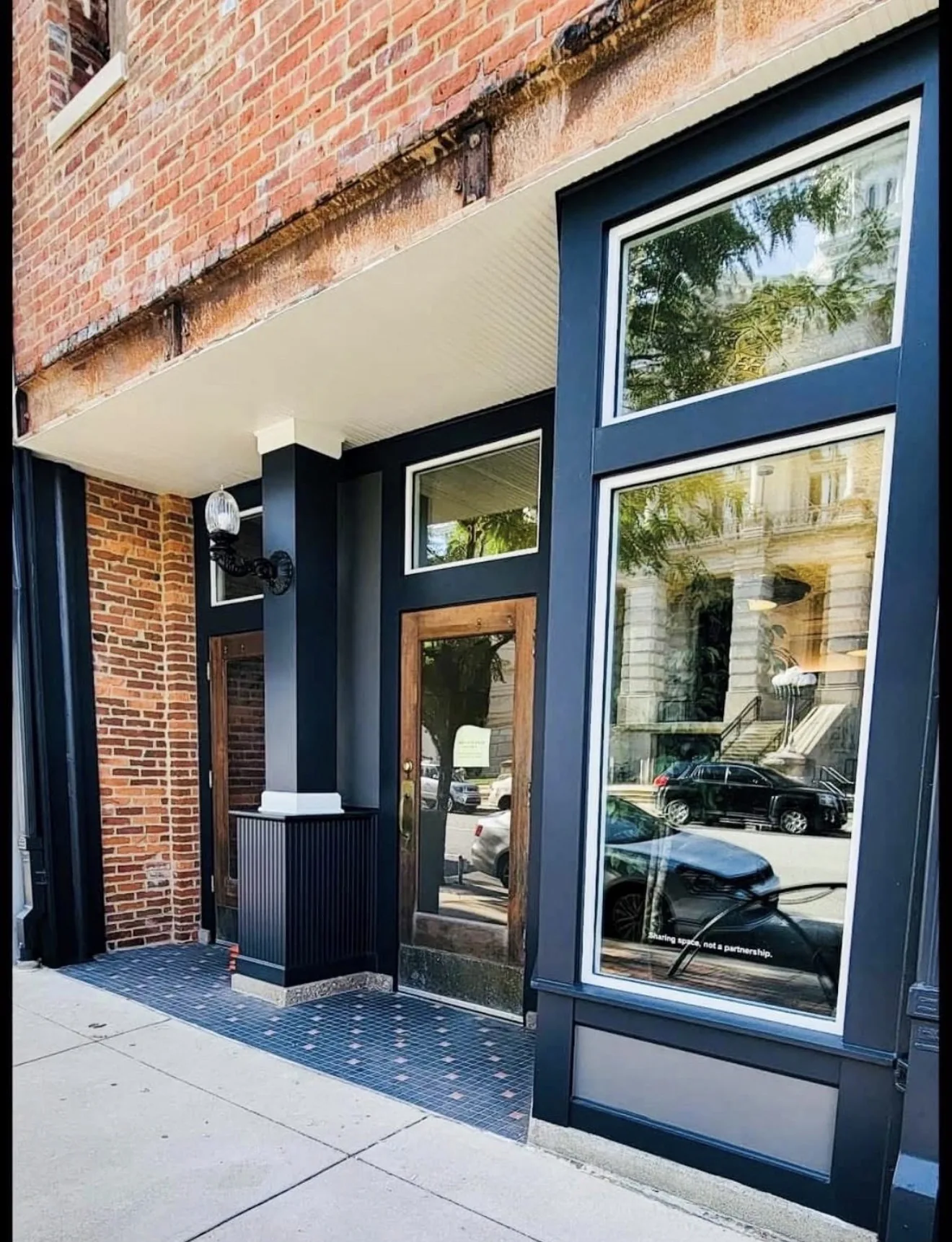 Jones & Sons commercial painting project at a storefront entrance.