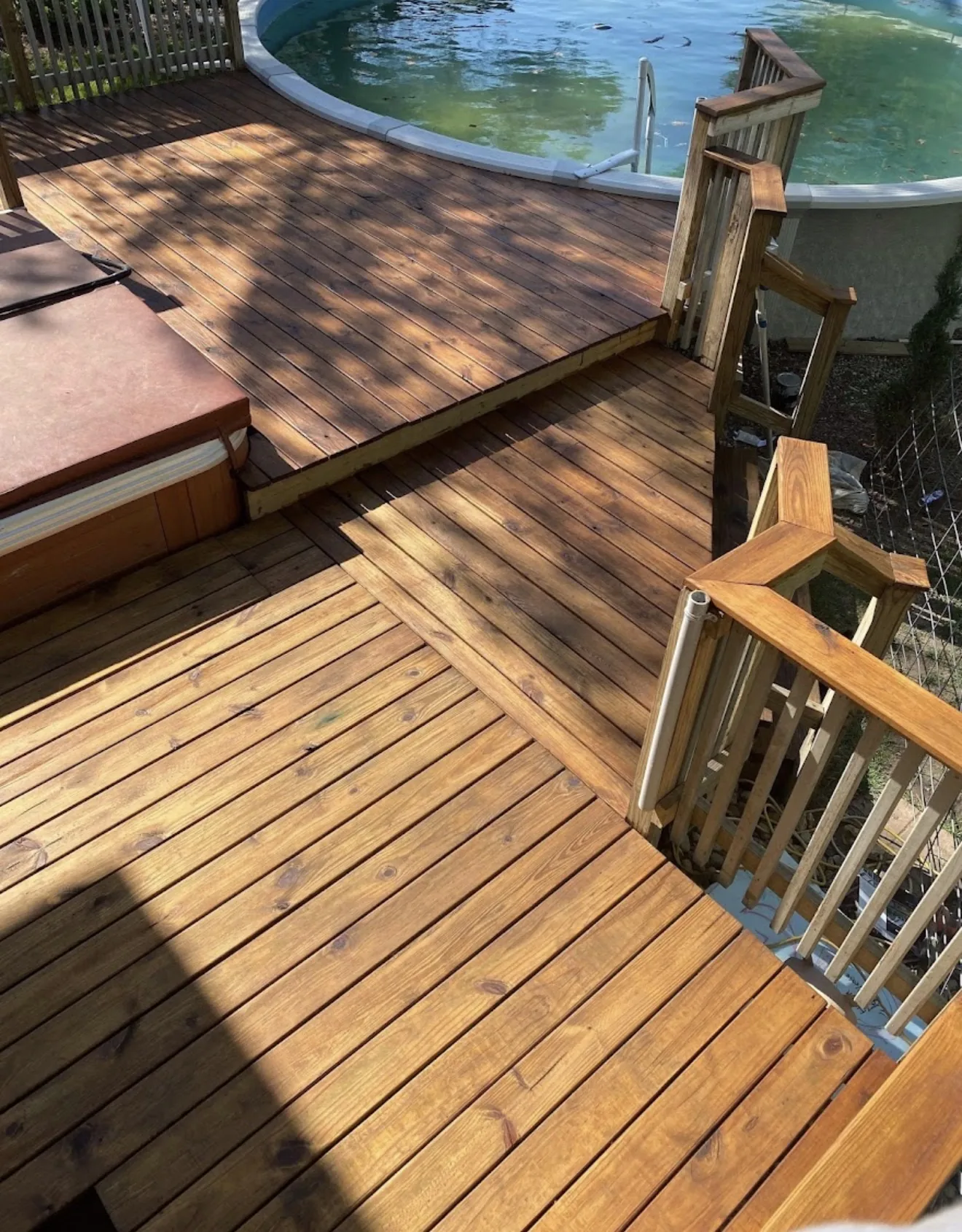 Jones & Sons deck and fence staining project in an outdoor space.